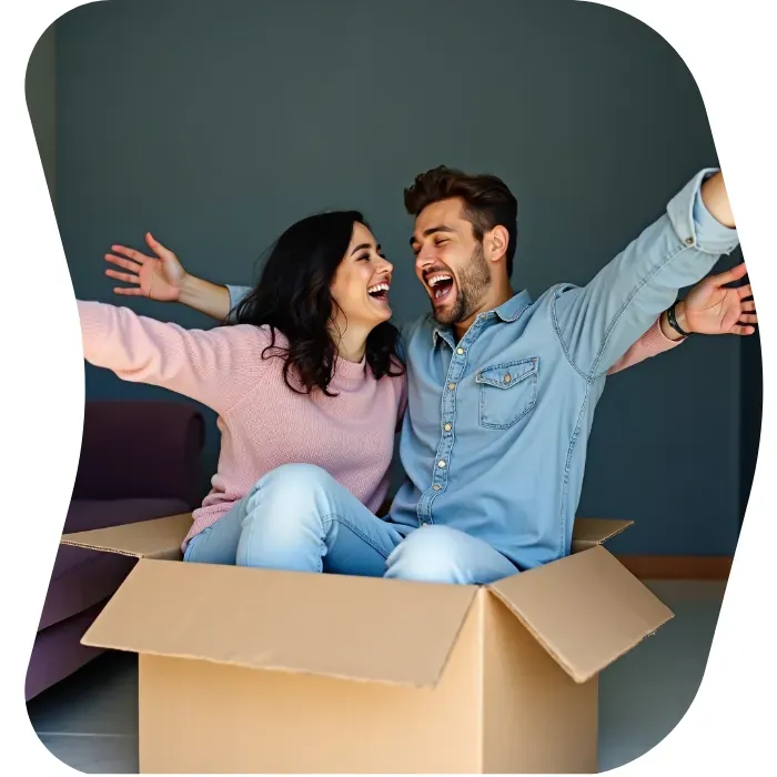 Two guys sitting on the floor of their apartment with Muval moving boxes